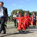 Chris Oldham, the ChristChurch Cathedral Administrator, leads the choir onto Hagley Park.