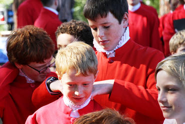 Frazer Densem adjusts the ruff of Ben Johnson before the Cathedral Choir takes the stage.
