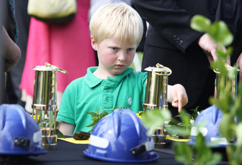 One of the younger brigade inspects the table of tributes to the miners.