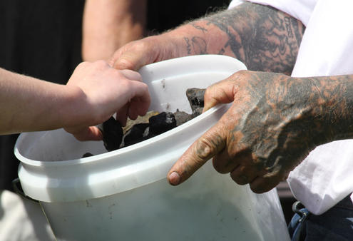 The mourners were invited to take a piece of coal and place it in the old pickup truck - as a symbol of shifting their burden of grief.