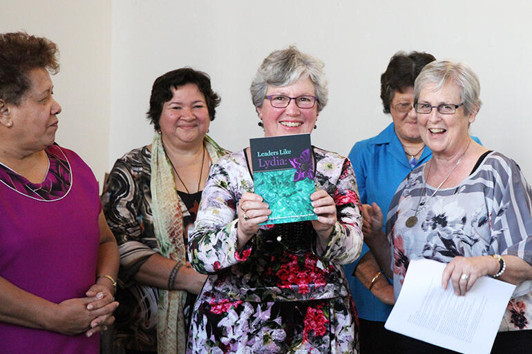 The Rev Lynne Frith brandishes the new book, flanked by the Revs Amy Chambers (L-R), Brenda Sio, Jenny Quince and Erice Fairbrother. 