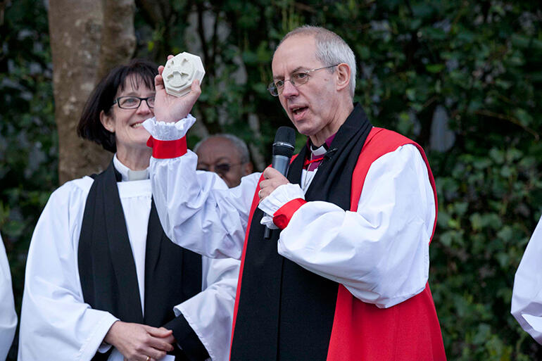 Archbishop Justin Welby presents Dean Jo with a stone "boss' from Canterbury Cathedral. "Just to remind you..." he quipped.