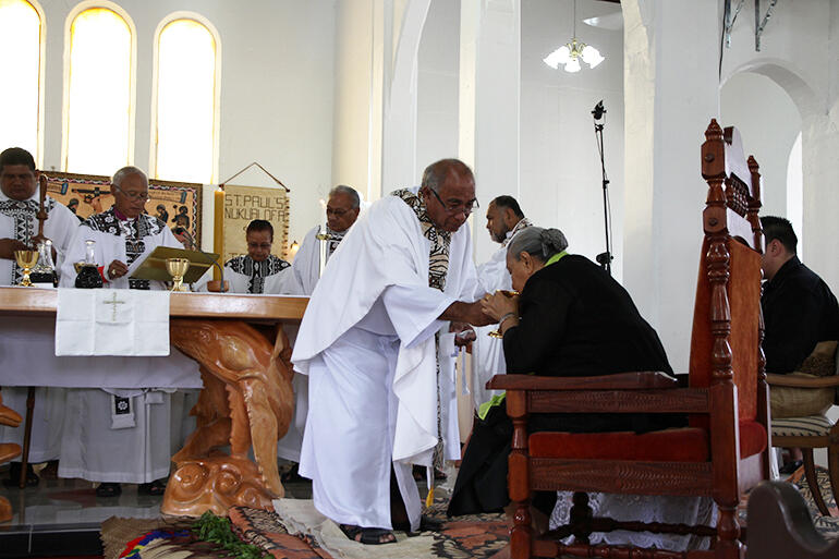 Archdeacon Joe Le'ota administers the chalice to Her Majesty Queen Halaevalu Mata’aho. She was present for the Saturday rededication.