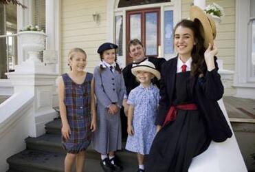 Dio students (from left) Hannah Bell, Natasha Levene, Sydney Bell and Emily Showell model uniforms being archived by Evan Lewis.