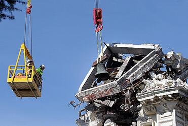 Workmen remove a bell from the Cathedral of the Blessed Sacrament in Christchurch. Photo: The Press
