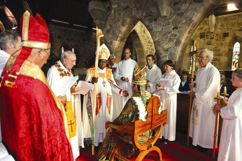 Archbishop John Sentamu seats the Bishop of Taranaki in his new cathedra. Note the white feather trim on Bishop Philip's cope.