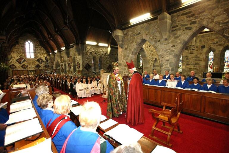 Archbishop Sir Paul Reeves leads Bishop Philip Richardson to his new cathedra.