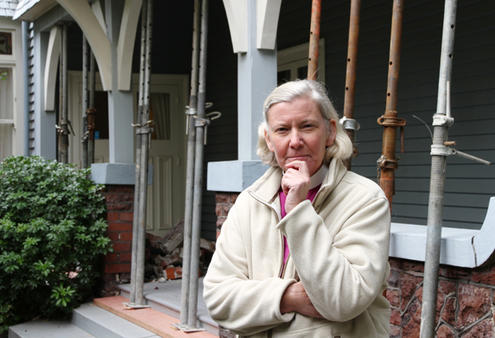 Twenty props now hold up the dangerously sagging overhanging corner of Bishop Victoria's home. Note the rubble in the backdround.