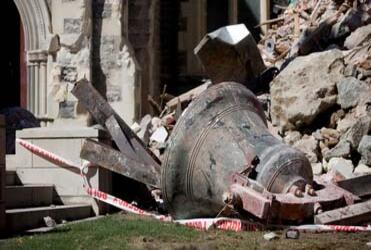 One of the cathedral bells lies amid the rubble of the tower. Photo: NZ Herald