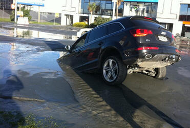 A car sinks into liquefaction following the latest aftershocks in Christchurch. Photo: Tim Kelleher