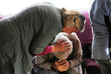 Bishop Victoria consoles and prays for a man who wasn't expecting to have to leave Churchill Courts. Photo: Lloyd Ashton