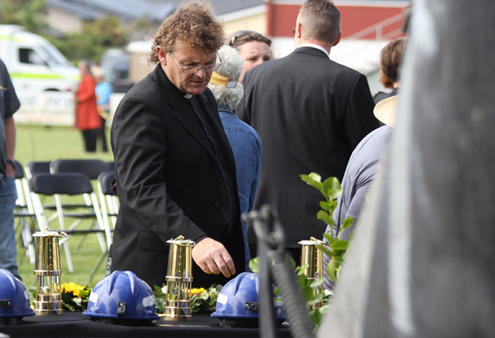 Tim Mora pauses to reflect as he passes the table of tribute to the lost miners.