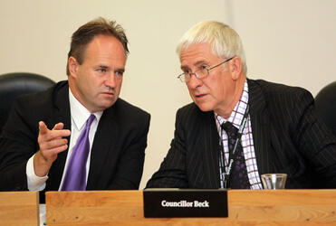 Cr Peter Beck (right) receives advice from Cr Glenn Livingstone at his first council meeting. Photo: Kirk Hargreaves