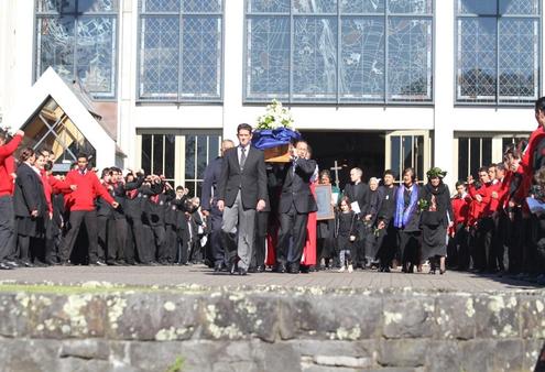 Sir Paul is borne shoulder high to the waiting hearse as hundreds of school kids perform a haka.