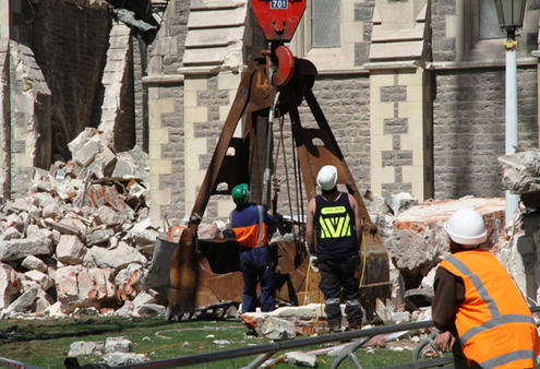 A massive crane lifted this giant bucket to the top of the tower, and used it to chomp off tonnes of unsafe masonry.