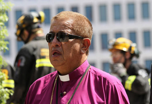 Bishop John Gray pauses as he pays tribute to those who perished at the cathedral, and commends them to God.