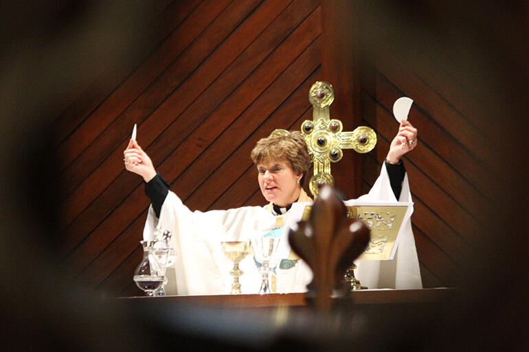 Dean Anne Mills breaks the bread. Dean Anne Mills breaks the bread.