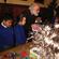 Dr Rowan Williams digs out the tinsel to decorate the Lambeth Palace Christmas tree, aided by children from Bonneville primary school, Clapham.