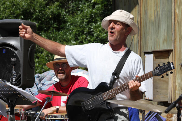 Evan Barraclough, guitarist with the Sendam Raucous-tra, works the crowd. And that's the Rev Richard Noble on congas. Evan Barraclough, guitarist with the Sendam Raucous-tra, works the crowd. And that's the Rev Richard Noble on congas.