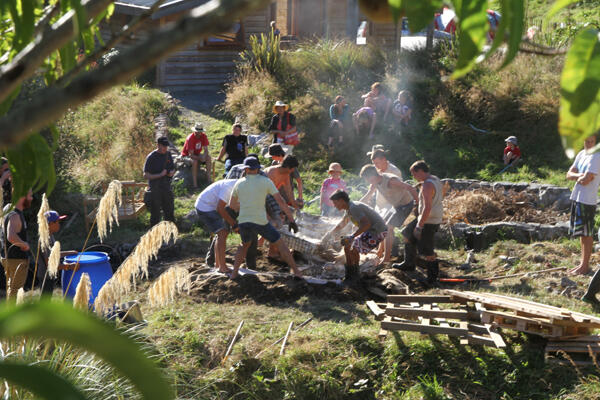 Saturday evening's meal surfaces from the firepit. Ngatiawa folk love a good hangi. 