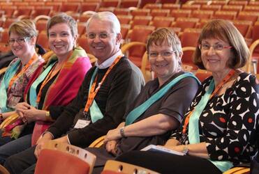 Safe Churches Consultation members front up in sashes to alert ACC members to their cause.