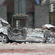 A car is flattened by rock from the cathedral spire. Photo: Lloyd Ashton
