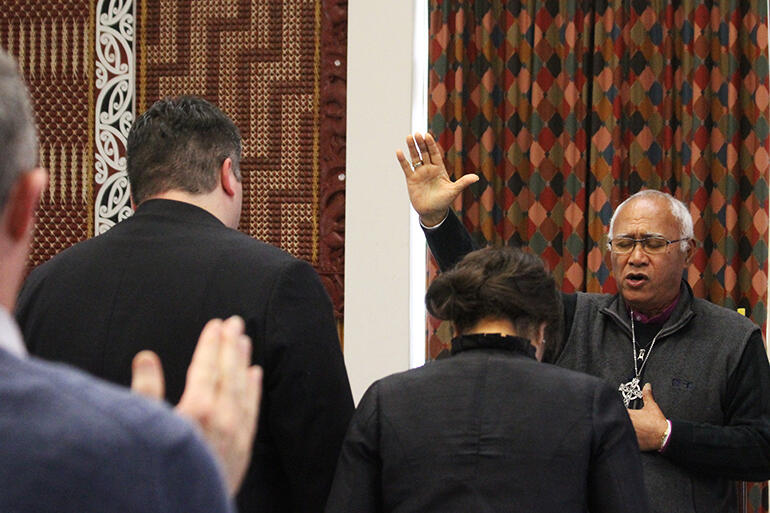 Archbishop Winston Halapua prays a blessing over Michael and 'Ala.