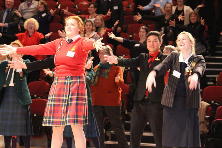 Students lead the Anglican Schools Conference in dance in St Margaret’s auditorium. 