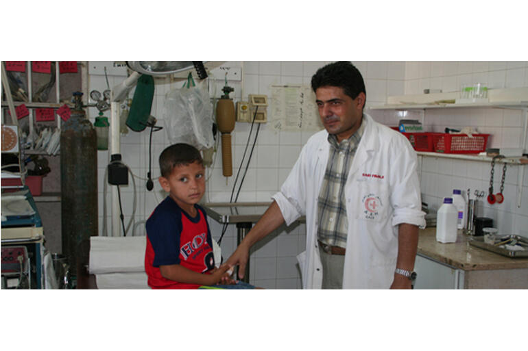 A doctor at Al Ahli Hospital treats a young Gazan resident. A doctor at Al Ahli Hospital treats a young Gazan resident.