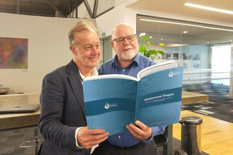 Auckland City Missioner Chris Farrelly looks over the Whakamana Tāngata report with NZCCSS Executive and WEAG member Trevor McGlinchey. Photo: NZCCSS. Auckland City Missioner Chris Farrelly looks over the Whakamana Tāngata report with NZCCSS Executive and WEAG member Trevor McGlinchey. Photo: NZCCSS.