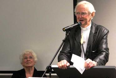 The Rev Dr George Armstrong pays tribute to his father in law, Archbishop Allen Johnston, at General Synod. Allen's daughter, Jocelyn, looks on. 