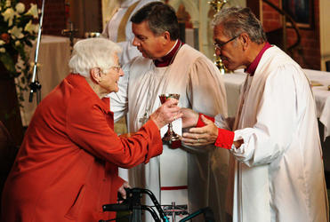 Bishop Rahu Katene administers the cup of blessing during the Synod Eucharist.