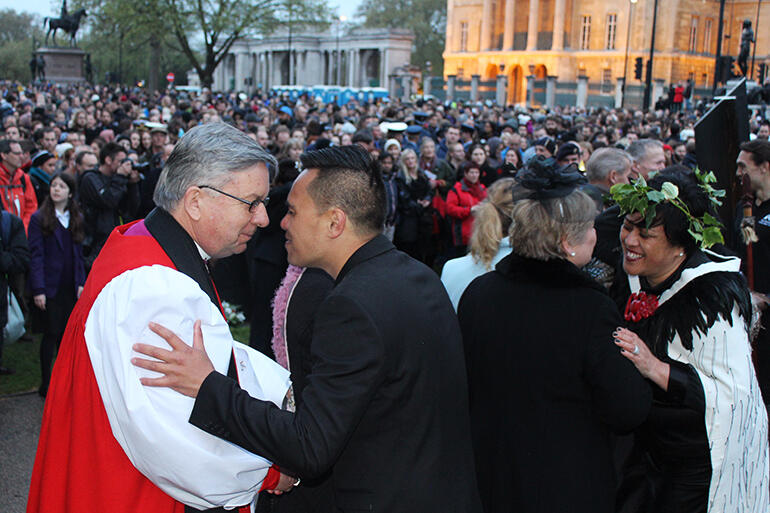 Archbishop Sir David Moxon hongis members of Ngati Ranana after the dawn service in Hyde Park.