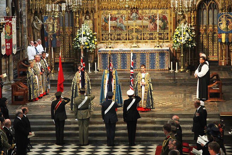 Officers from the Turkish, New Zealand, Australian and UK defence forces salute their flags in the Abbey. That's Bishop Pikaahu in the sanctuary.