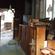 View of the nave from the choir-room corridor at the east end. The portable organ console is just below the chancel.