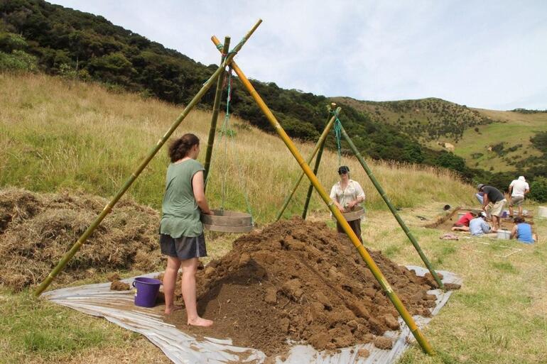 Archaeologists and students from the University of Otago excavating the site of the missionary settlement, just above the Marsden Cross. 