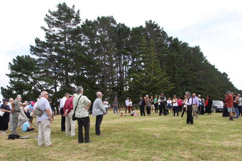 Hugh Rihari speaks during the powhiri. Folk are standing the site where The Interpretive Centre will be built.