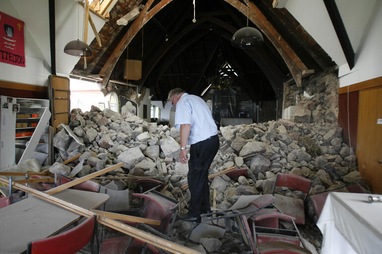 Lyttelton's vicar, Neil Struthers, picks through the rubble of Holy Trinity. Photo: Kirk Hargreaves/The Press.
