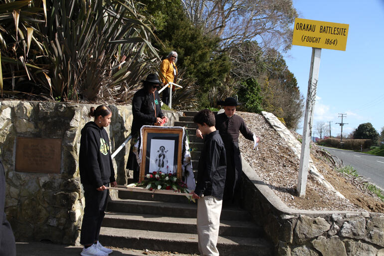 The icon of Mary precedes Anglo-Catholic pilgrims on the ascent to the Oraakau battle memorial site.