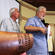 Rev Tom Van Culin, from Hawaii, reports from the men's caucus. Ian Sparks (left) and John Rea (both from the UK) stand in support.