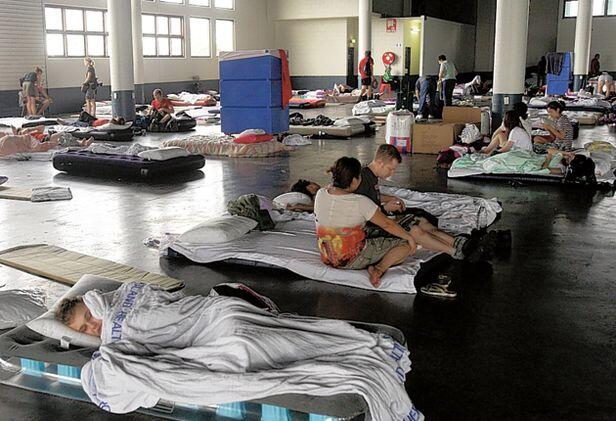 Flood victims doss down in a Brisbane evacuation centre.