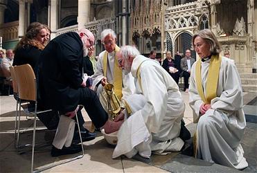 Dr Williams washes churchgoers' feet during the Maundy Thursday service at Canterbury Cathedral. Photo: PA