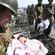 A rescuer weeps for joy as he cradles a 4-month-old child found alive after three days in a ruined house in northern Japan. Photo: AP