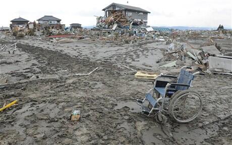 A wheelchair sits forlorn amid the desolation of a town in northern Japan.