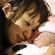 An unidentified mother watches her baby who was born on March 12 at a shelter in Iwaki, Fukushima. Photo: Reuters