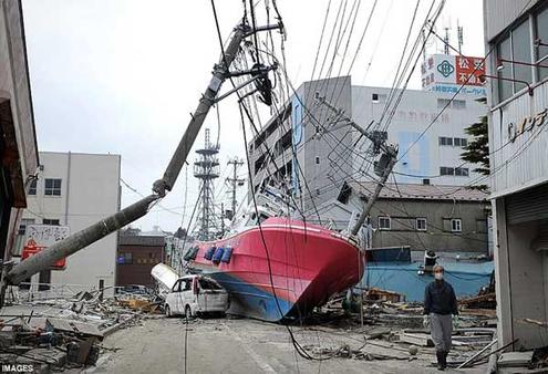 A boat is dumped in a street of Hishonomaki, Miyagi, after being swept inshore by the tsunami. Photo: AFP/Getty