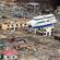 A ship is perched on top of a house in the tsunami-devastated remains of Otsuchi, Iwate prefecture. Photo: EPA