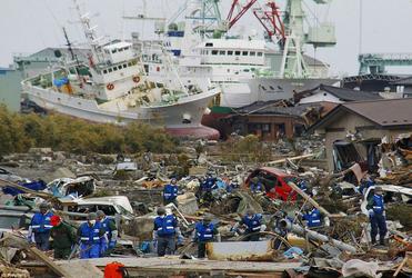 Japanese soldiers search for bodies in Higashimatsushima City, Miyagi, where up to 10,000 people may have died. Photo: Reuters