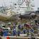Japanese soldiers search for bodies in Higashimatsushima City, Miyagi, where up to 10,000 people may have died. Photo: Reuters