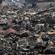Rescue workers are dwarfed by the rubble as they pick their way through the shattered city of Otsuchi. Photo: Reuters